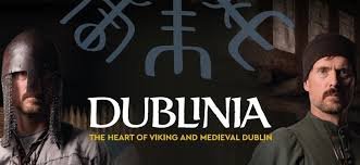 Viking Actors beside Dublinia Logo