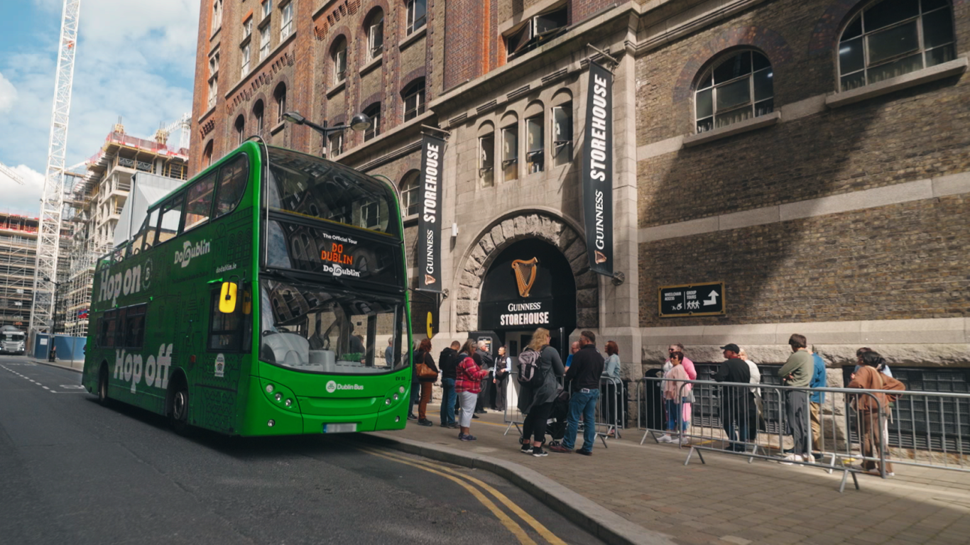 green bus outside guinness store house 