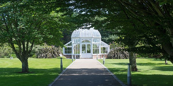 Path leading up to white glasshouse at Malahide Castle Gardens